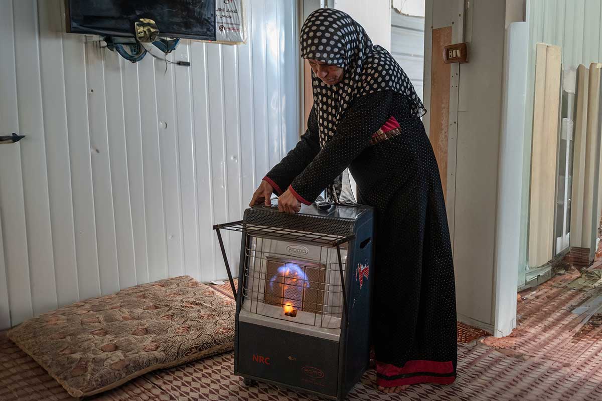 A woman starting a heating device