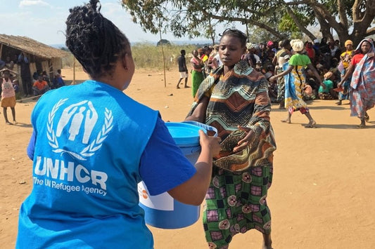 UNHCR staff distributes a dignity kit to support displaced women in Chiure, Mozambique.