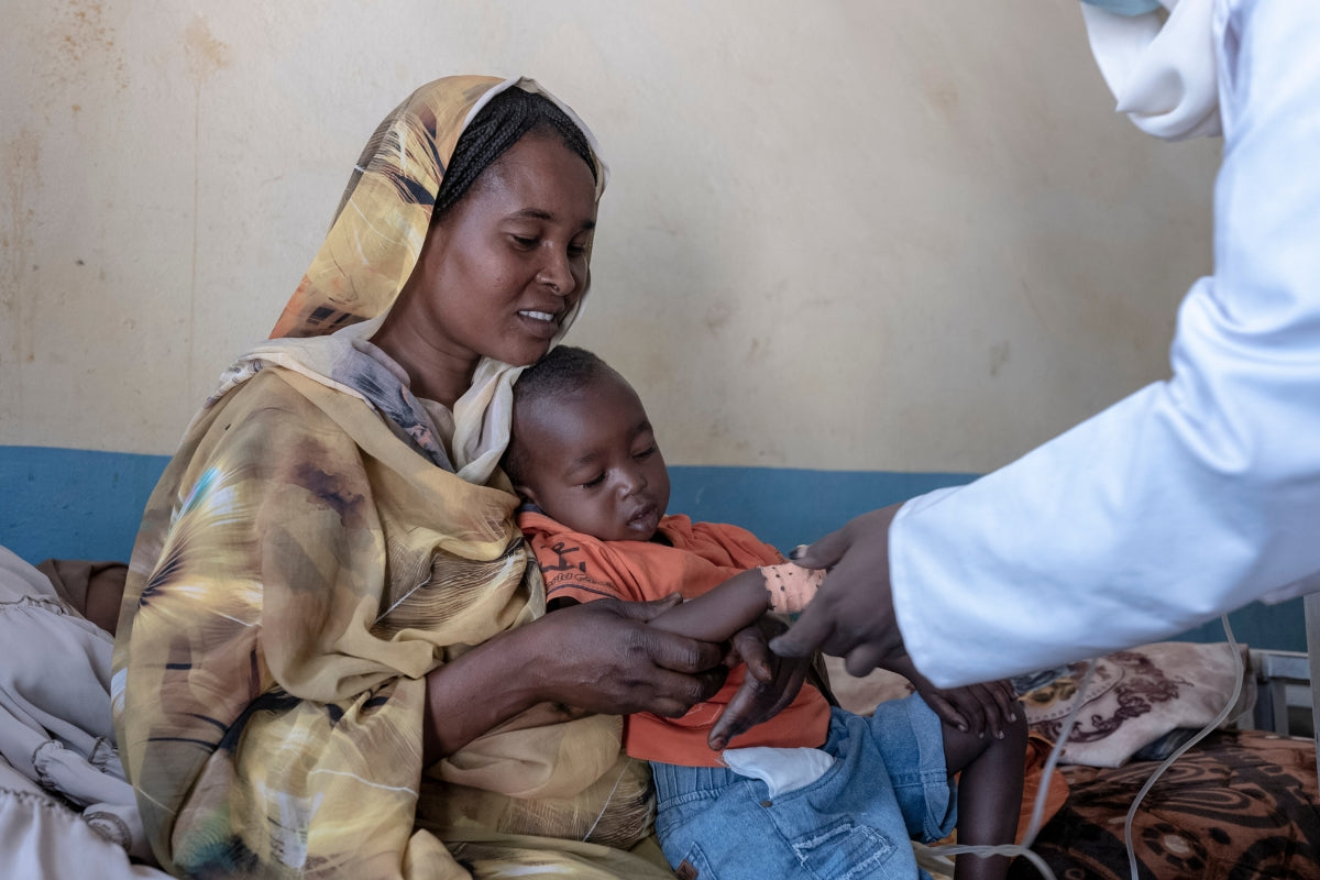 A mother and child in Sudan visit a doctor for a checkup