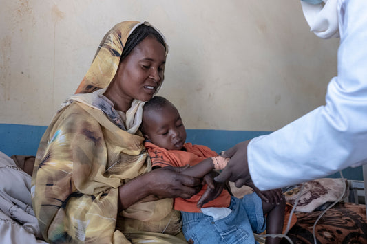 A mother and child in Sudan visit a doctor for a checkup